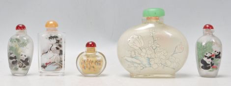 A group of five Oriental Chinese glass painted perfume scent bottles of varying form and decoration.