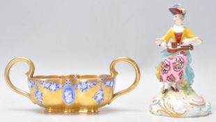 An antique Coalport twin handled small gilt cabinet dish / basket having blue and white transfer