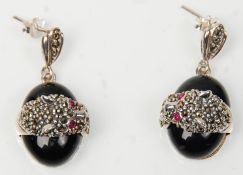 A pair of stamped 925 silver drop earrings in the form of leopards upon black onyx stones, set