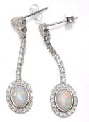 A pair of ladies silver drop earrings set with oval opal panels and CZ's. Weight 4g. Measures 3.