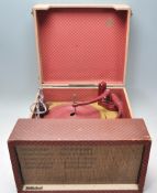 A vintage retro 20th Century two tone portable MCMichael record player having bakelite knobs and