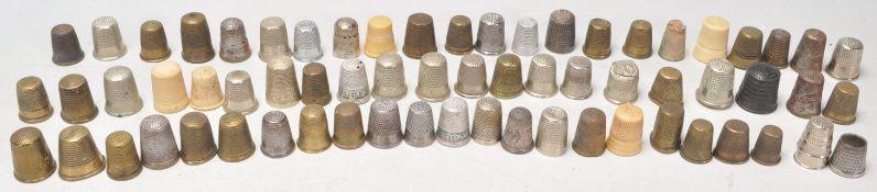 A collection of vintage and antique thimbles to include brass, white metal and ivorine. Over 50.