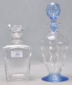 Two vintage 20th Century glass decanters to include a blue glass bottle decanter with a bulbous form