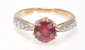 A 9ct gold  Birmingham hallmarked red and white stone ring. The large round cut red stone with white
