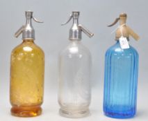 A group of three 1930's vintage advertising soda siphon's to include a blue glass Hooper & Struve