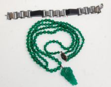 A lovely early 20th Century Art Deco green glass bead necklace with a decorative carved pendant with