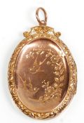 A vintage 9ct yellow gold back and front locket pendant of oval form having engraved swallow