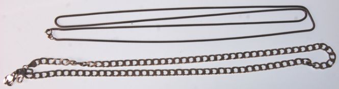 Two long silver necklace chains. One being a snake link example having a spring ring clasp. Measures