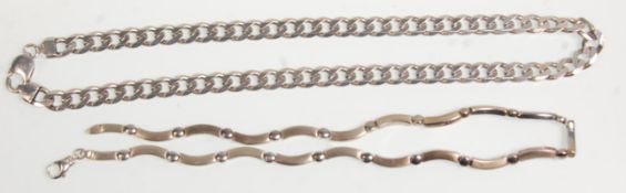 Two silver necklaces to include a curved link necklace joint together by rounded joints having a