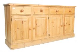 A large  antique victorian style country pine dresser base sideboard being raised on a plinth base