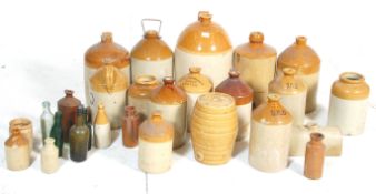 A collection of antique and vintage stoneware cider jars many names with different breweries to