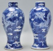 A pair of late 19th Century Chinese blue and white baluster vases having hand painted pairs of