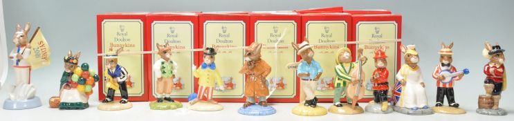 A group of twelve Royal Doulton Bunnykins ceramic figurines to include England Athlete Bunnykins