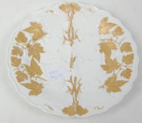 A 19th Century German Meissen porcelain plate having gilded vine decoration with moulded details.