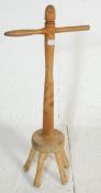 A 19th Century Victorian antique wooden dolly stick having a carved column with handle to the top.