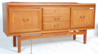 A vintage 20th century teak wood sideboard having a central bank of three drawers flanked by