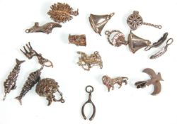 A great group of seventeen silver charms to include a bedpan, Victorian shoe, 2x feathers, 2x boats,