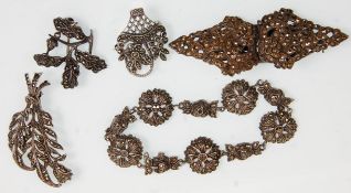 A group of five pieces of silver and marcasite ladies jewellery to include brooches and a decorative