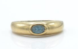 A 9ct gold and sapphire dome ring. The ring set with oval facet cut sapphire in domed ring with