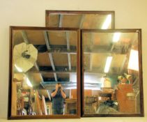 A group of three 20th Century large ex shop / haberdashery display wall mirrors each having carved