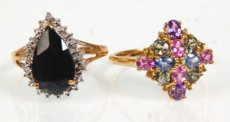 Two 9ct yellow gold ladies rings. One set with multi coloured round and oval faceted cut stones.