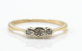 A 9ct gold platinum and diamond 3 stone ring. The ring set with 3 illusion set diamonds in