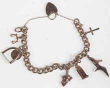 A silver charm bracelet having a heart padlock clasp. Adorned with various charms to include a
