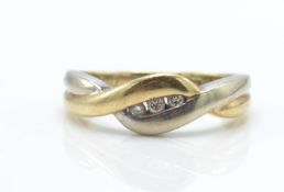 A 9ct gold and diamond bi-colour crossover ring.  The ring with white and yellow cross over design