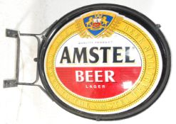 A good advertising Amstel Beer / Lager light box of oval form mounted to an iron bracket. H105cm