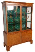 An early 20th Century 1930' Art Deco walnut china display cabinet having a cupboard base with twin