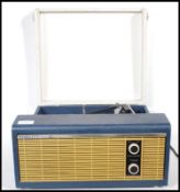 A vintage mid 20th Century Fidelity Solid State record player having a blue case with a grey lid,