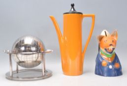 A vintage retro 20th Century Portmeirion coffee pot having an orange body with angular handle and