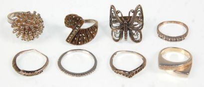 A collection of eight ladies silver rings to include two wishbone rings set with marcasites, a