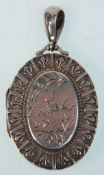 A 19th Century Victorian silver hallmarked locket having engraved swallow decoration and repousse