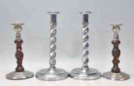 A pair of vintage Art Deco chrome candlesticks having barley twist columns and rounded bases.