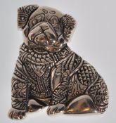 A stamped sterling silver brooch in the form of a pug dog having patterned decoration. Weight 9.