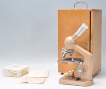A vintage Minipet ASA KL-4 microscope set within its original wooden case complete with glass slides