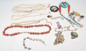A collection of vintage costume jewellery to include a turquoise and coral collar necklace, two