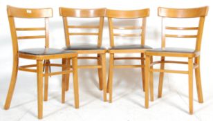 A set of four vintage retro 20th Century utility dining chairs having black leather seats with block
