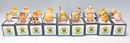 A collection of eighteen Pot Bellys carved resin figures to include builders, policeman, multiple