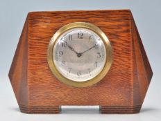 An early 20th Century 1930's  Art Deco oak cased mantel  clock of shaped angular form having a