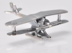 A stamped 925 silver figurine in the form of a biplane with targets to the wings. Weight 7.8g.