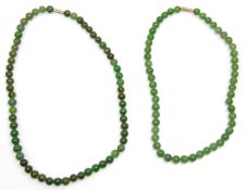 Two vintage mid century hard stone jade bead necklaces. Each having graduating beads with white