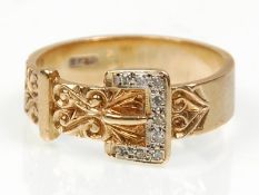 A good hallmarked 9ct yellow gold buckle ring set with diamonds and having decorative engraved