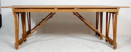 A pair of two mid 20th century vintage retro industrial folding trestle tables having wooden block