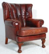 A 20th Century antique revival Chesterfield wingback armchair upholstered in oxblood leather