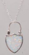 A stamped 925 silver pendant necklace having a shield design lock pendant set with an opal panel.