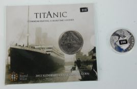 A commemorative 2012 Titanic £5 coin together with a silver proof 2012 R.M.S Titanic coin. Weighs