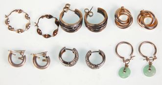 A group of six pairs of silver earrings to include a pair of crinkled hoop examples, a pair set with