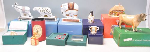 A mixed group of ceramic ornaments to include a Beswick Cow, Lilliput Lane cottage, 2X Royal Crown